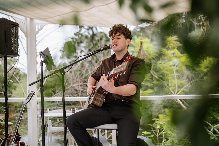 Harry Morris performing live with acoustic guitar
