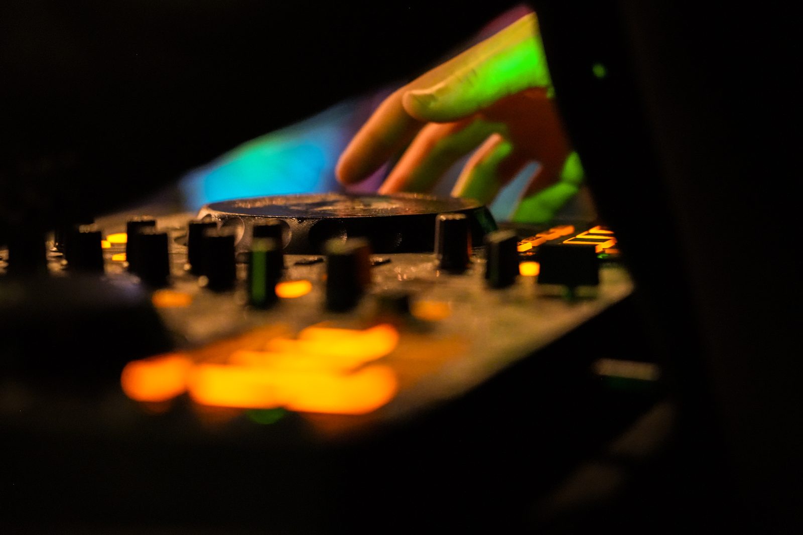 Close-up of the DJ controller under coloured light
